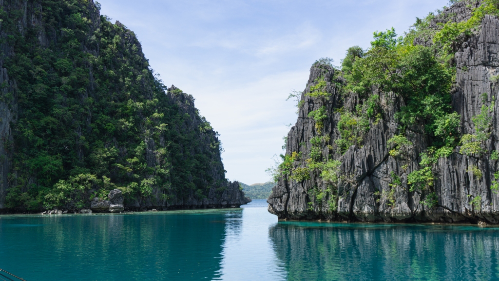 An opening between two limestone cliffs in the ocean in Coron, Palawan, Philippines.