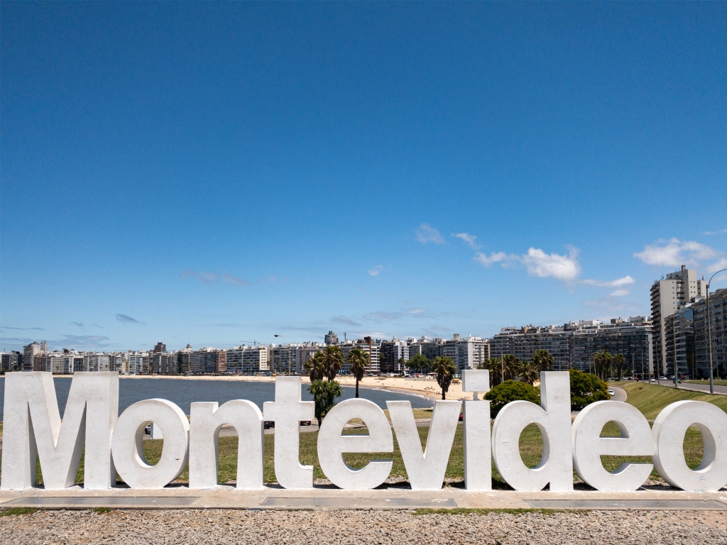 Big, white letters reading "Montevideo" in front of a beach in Uruguay.